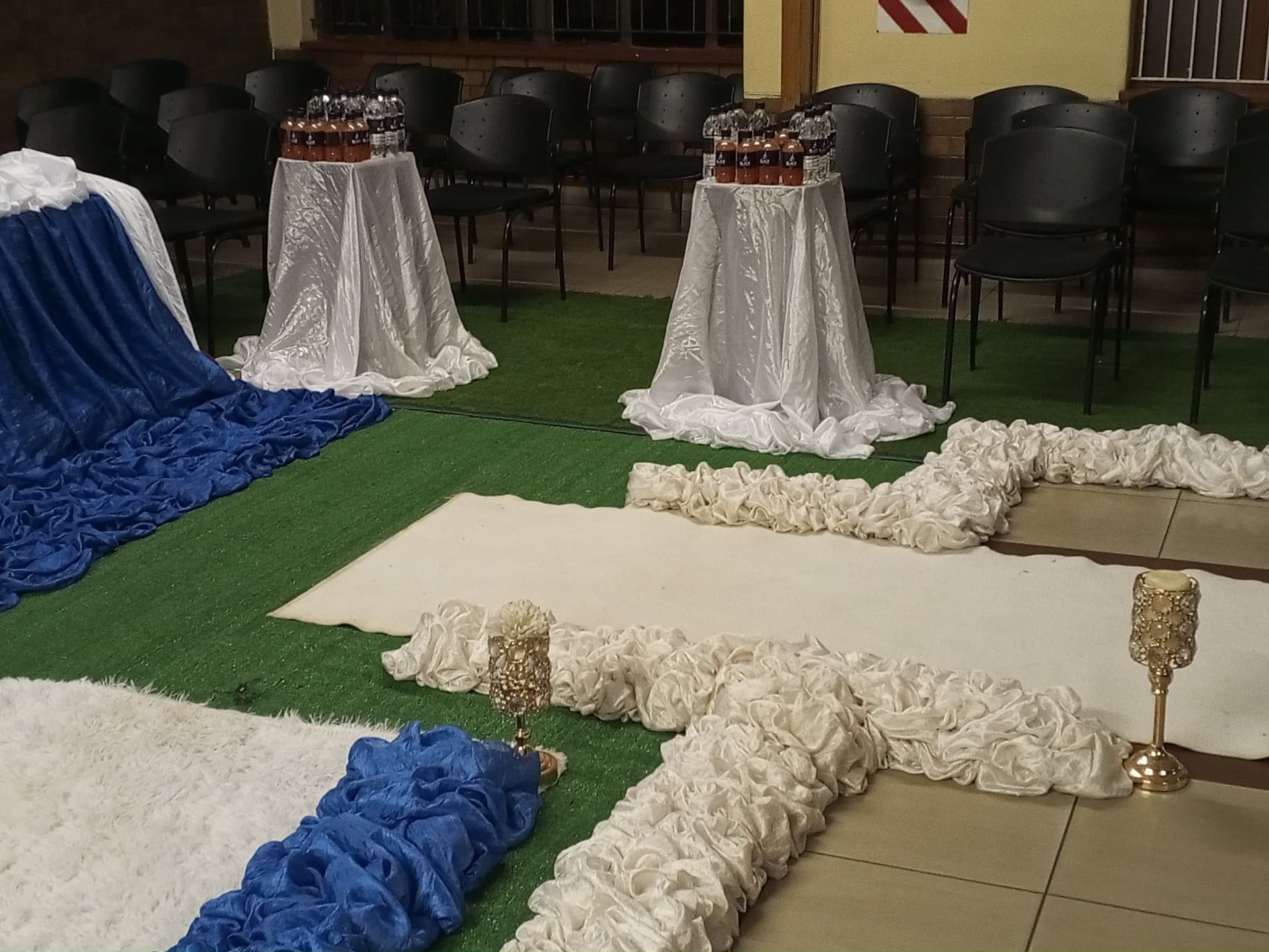 Beverage stations and white draping at an indoor gathering
